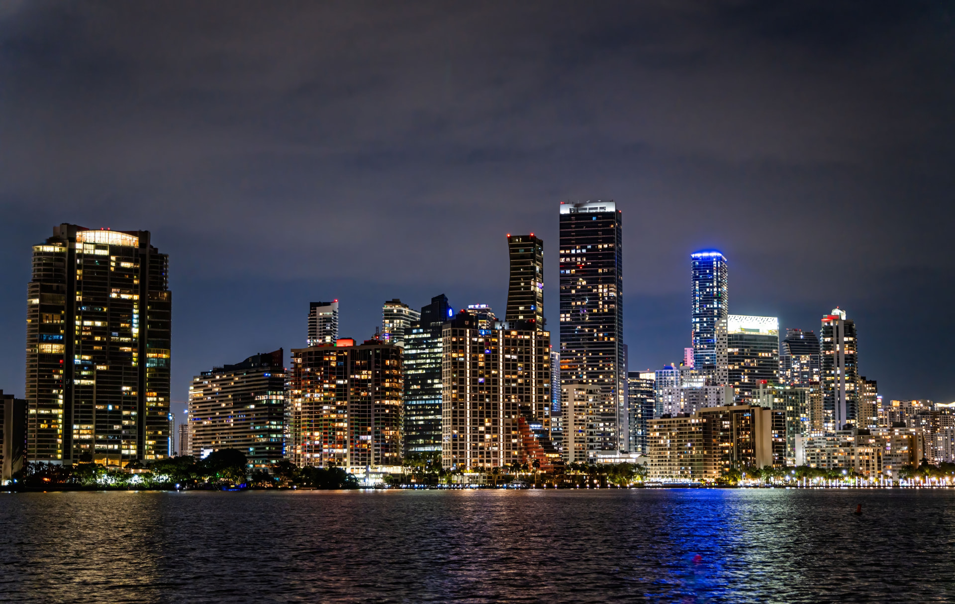 Miami skyline at night reflecting on Biscayne Bay